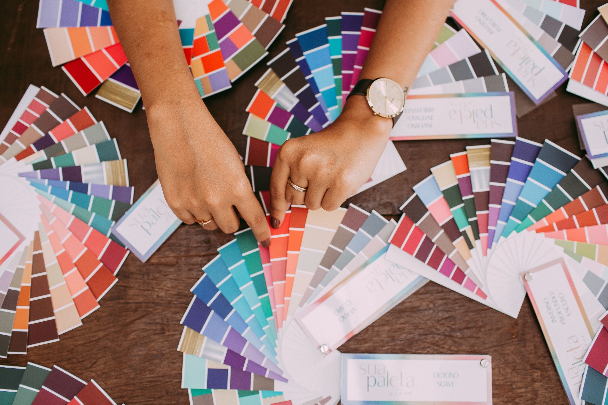 Hands comparing color palettes